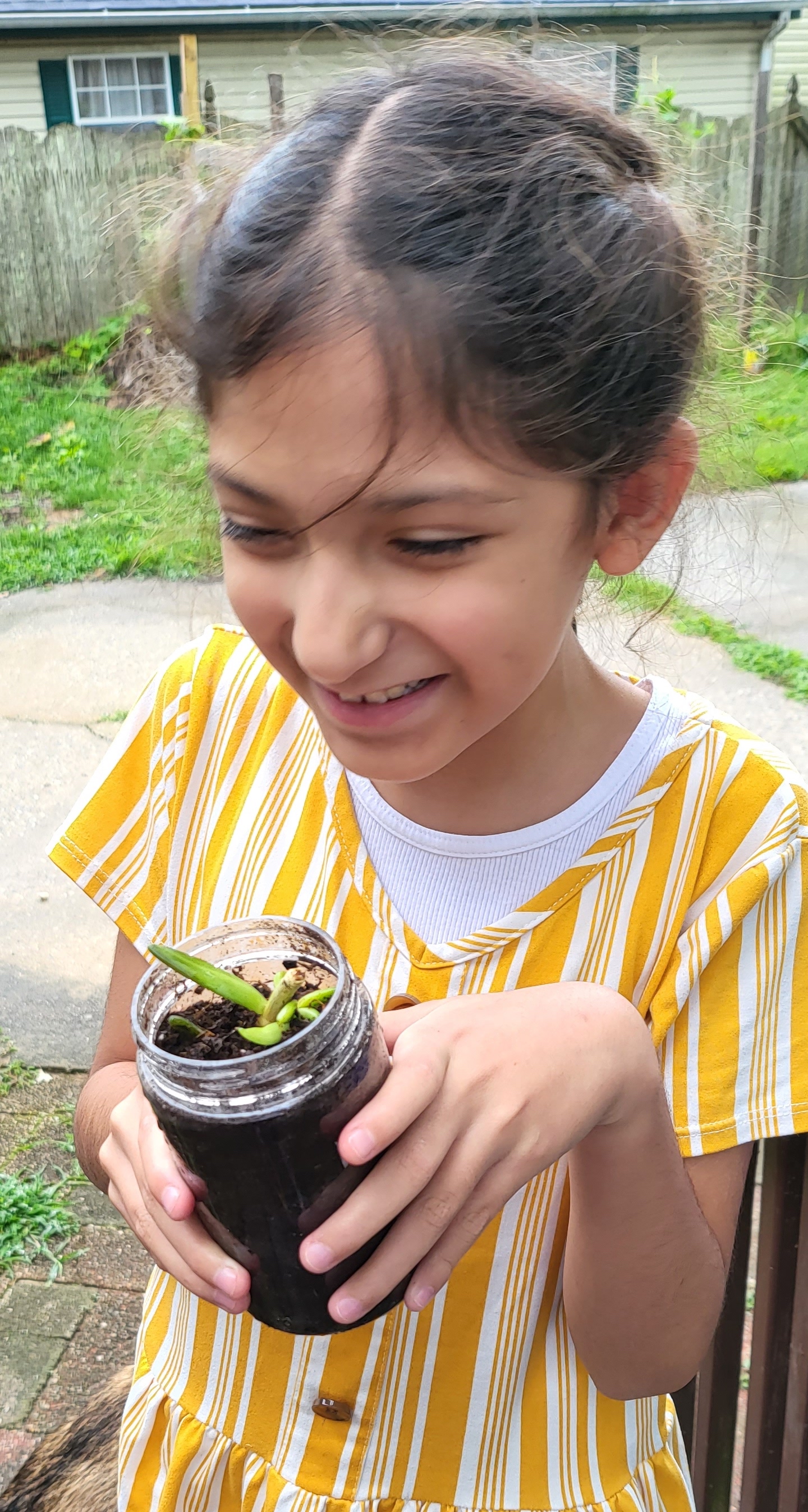 Sol and her baby plant.jpg